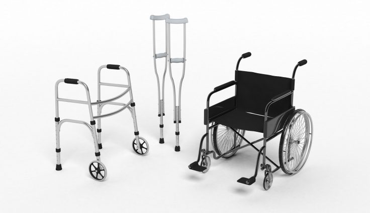 Black disability wheelchair, crutch and metallic walker isolated on white